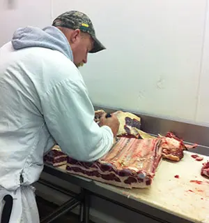 Picture of employee processing meat